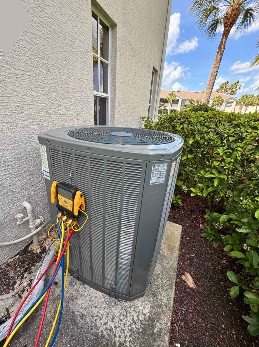 Residential outdoor air conditioning unit beside a house wall